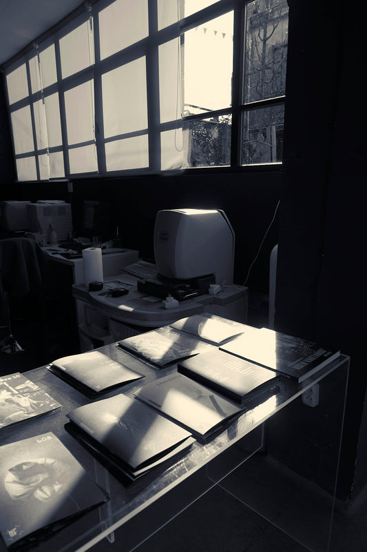 a desk with a computer monitor and some pictures on it