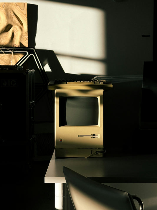 A small TV sitting on top of a desk next to a chair