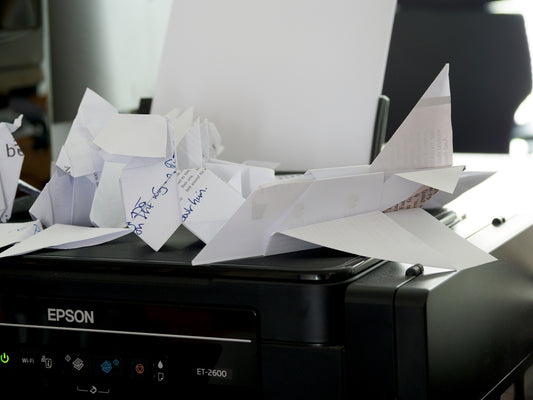 a bunch of papers sitting on top of a printer