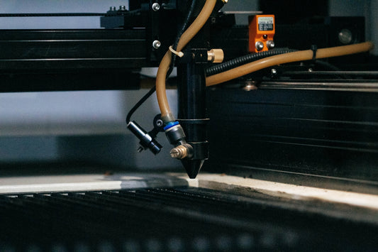 a machine that is cutting a piece of metal