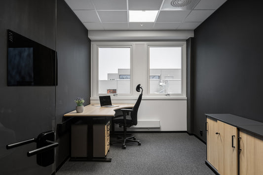 An empty office with a desk and chairs