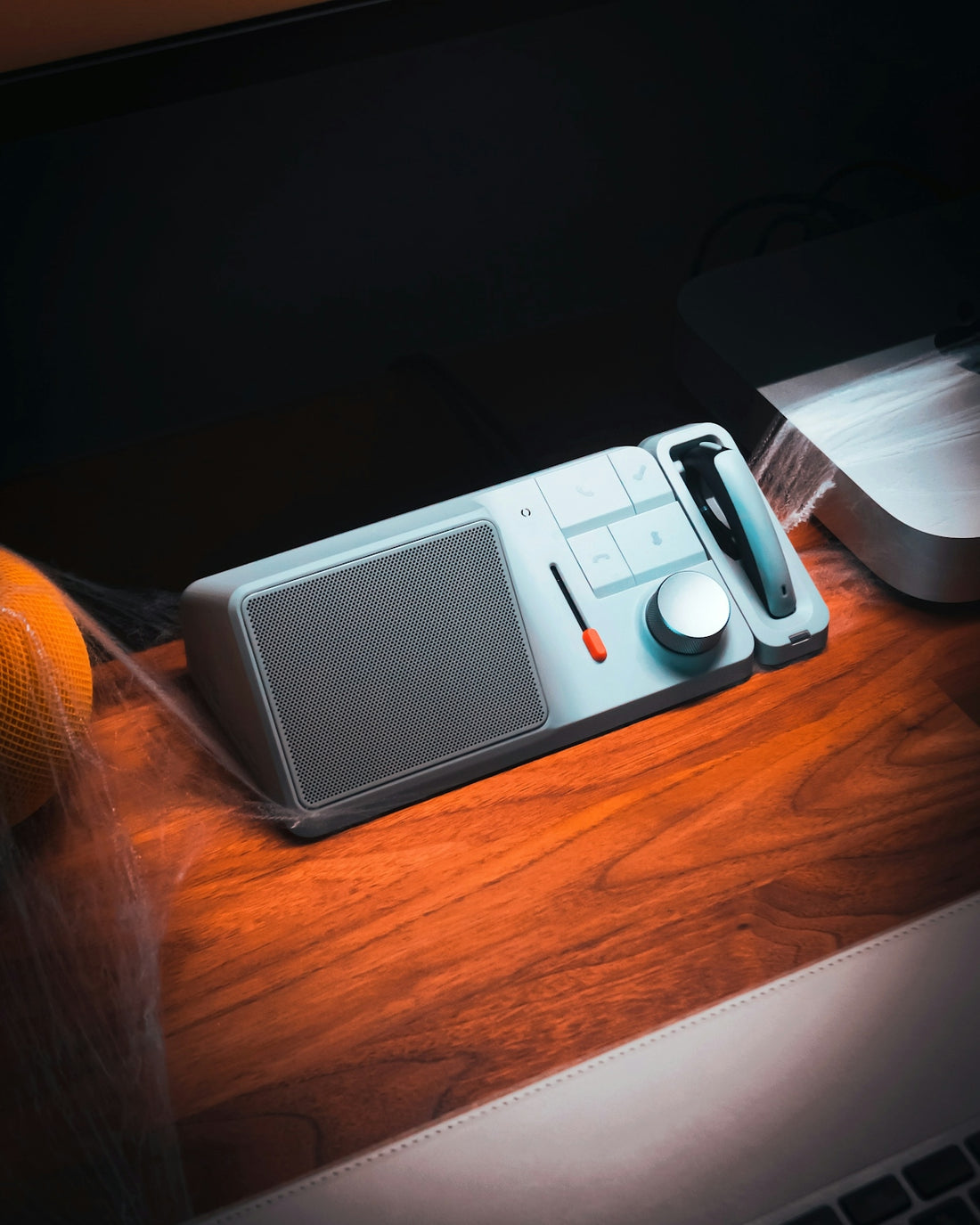 A desk with a laptop and a cell phone on it