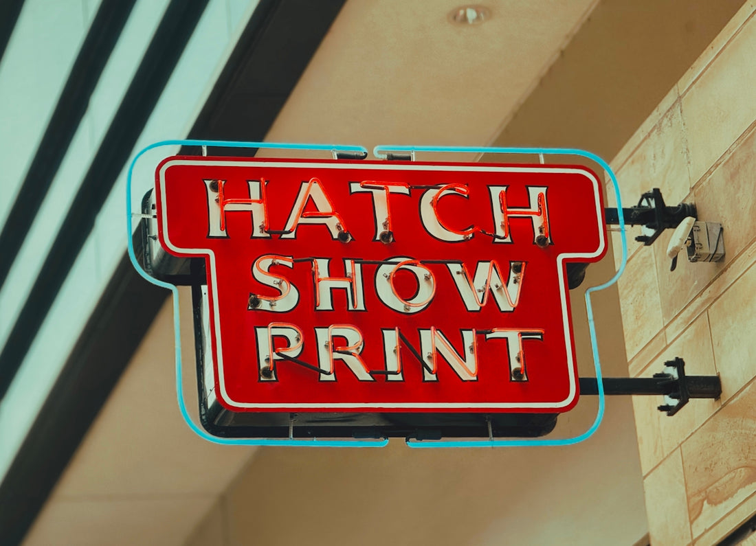 A red sign hanging from the side of a building