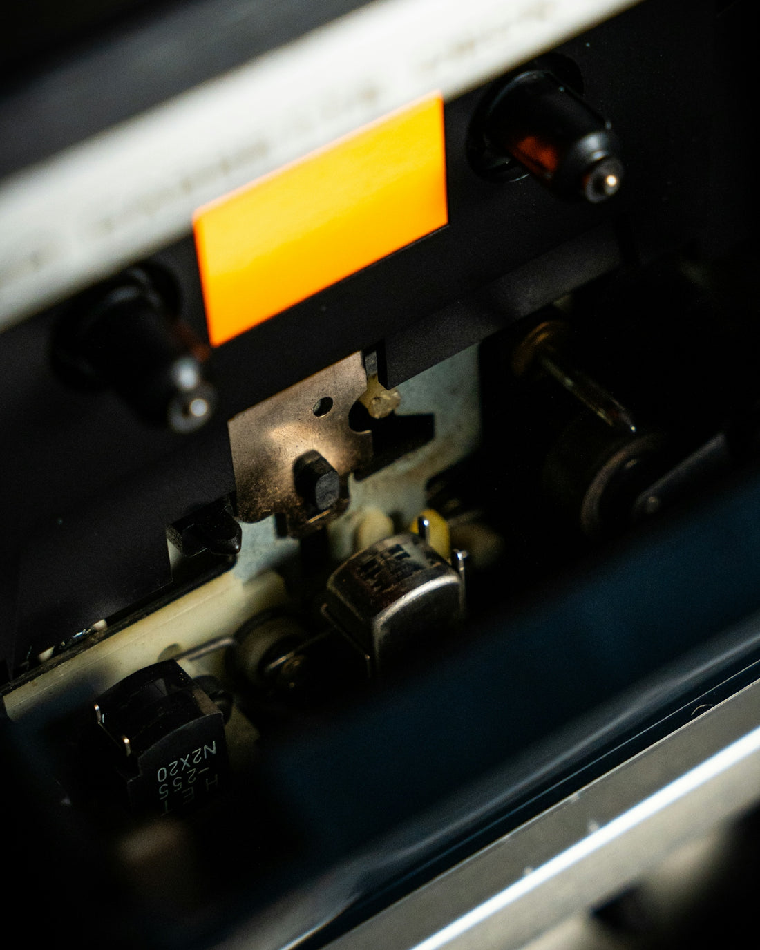 A close up of a machine with a yellow label on it