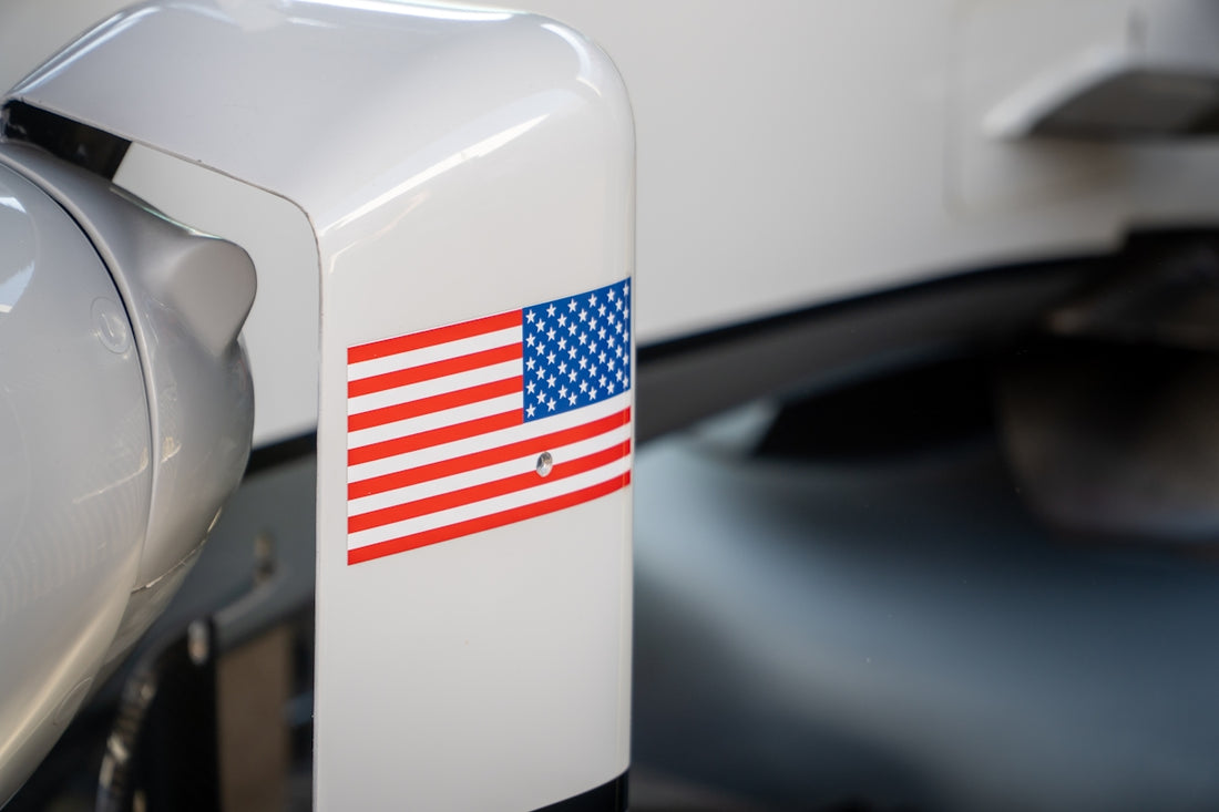 An american flag sticker is on a white surface.